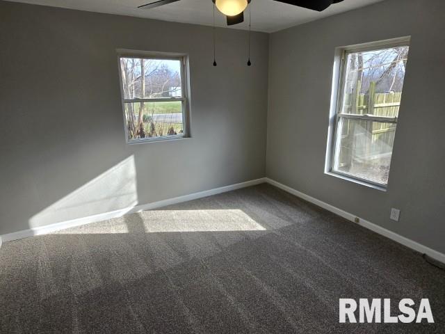 spare room with carpet flooring and ceiling fan