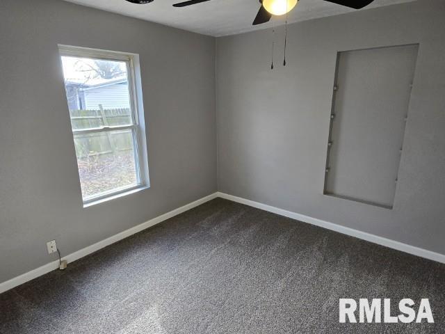 carpeted empty room featuring ceiling fan