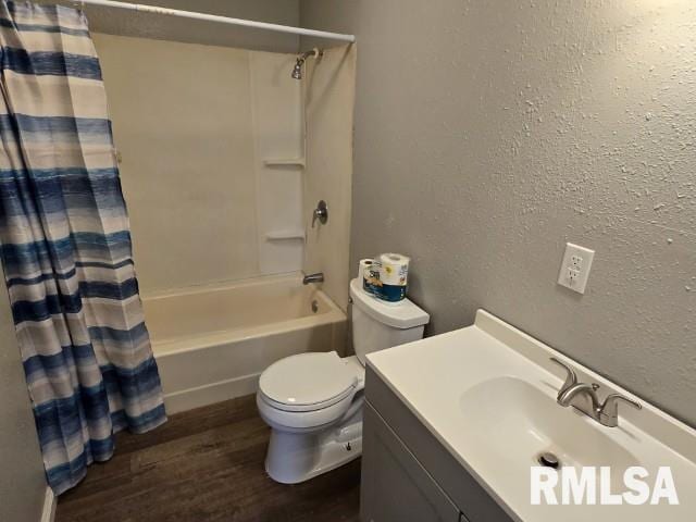 full bathroom featuring vanity, hardwood / wood-style flooring, toilet, and shower / bathtub combination with curtain