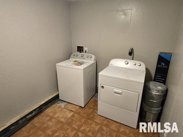 laundry area featuring light parquet floors and washer and dryer