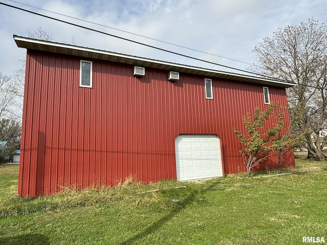 view of home's exterior featuring an outbuilding, a yard, a garage, and a wall mounted AC