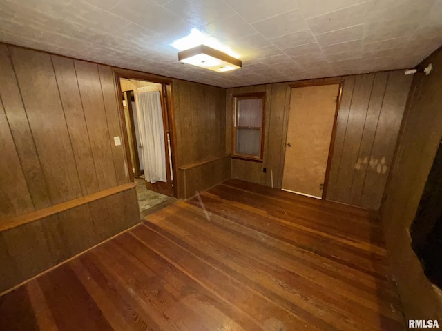 interior space with wooden walls and dark wood-type flooring