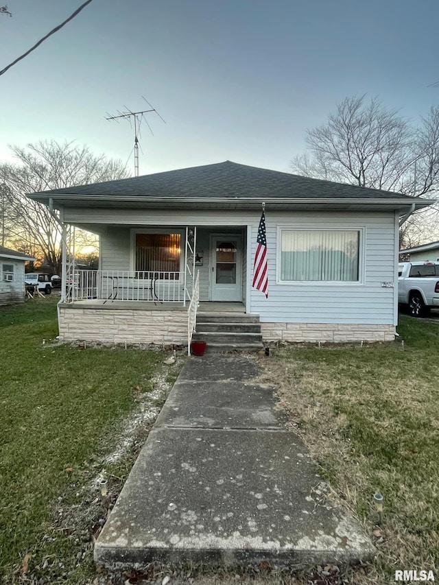 view of front of property with a lawn and covered porch