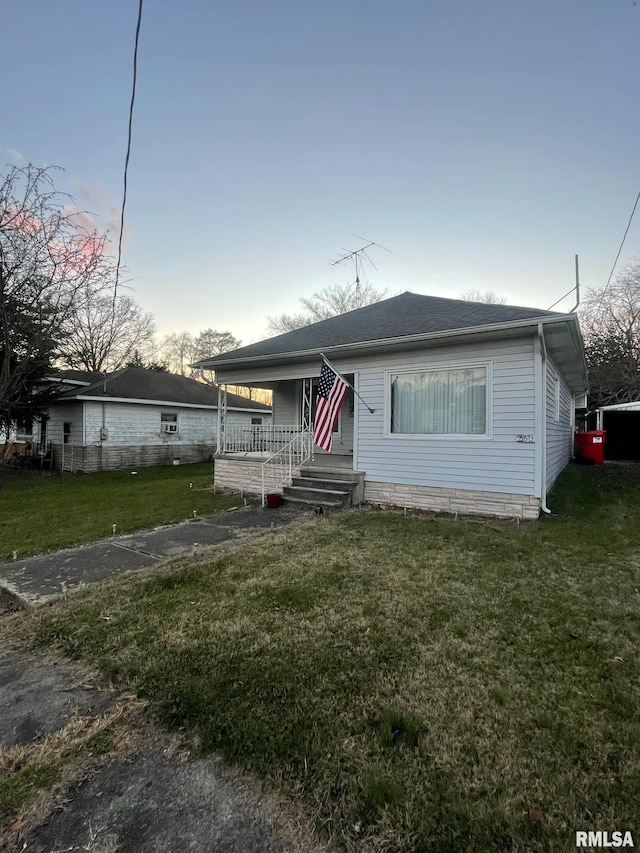 view of front facade with a yard and a porch