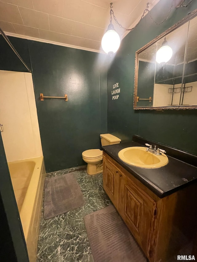 bathroom with vanity, toilet, and ornamental molding