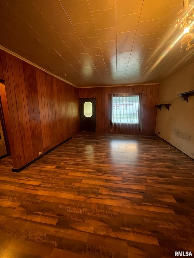 unfurnished room with hardwood / wood-style flooring and wood walls