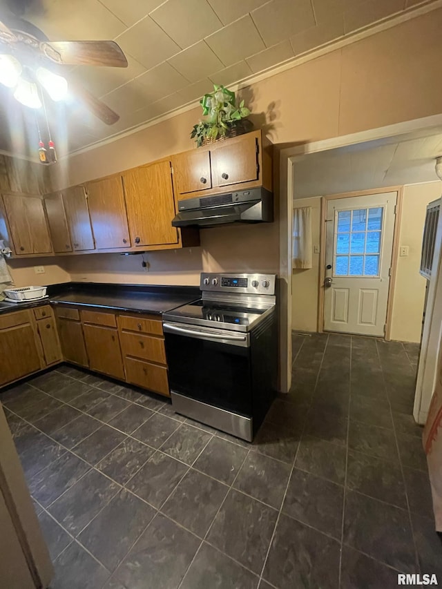 kitchen with dark tile patterned floors, stainless steel electric range oven, ceiling fan, and ornamental molding