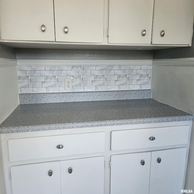 kitchen with white cabinets and decorative backsplash