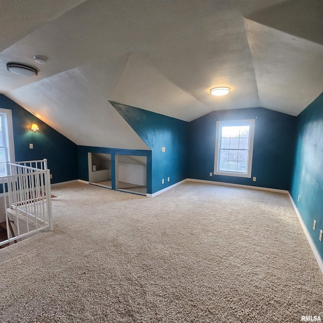 bonus room with carpet and vaulted ceiling