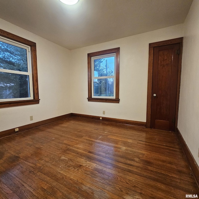 spare room with dark wood-type flooring