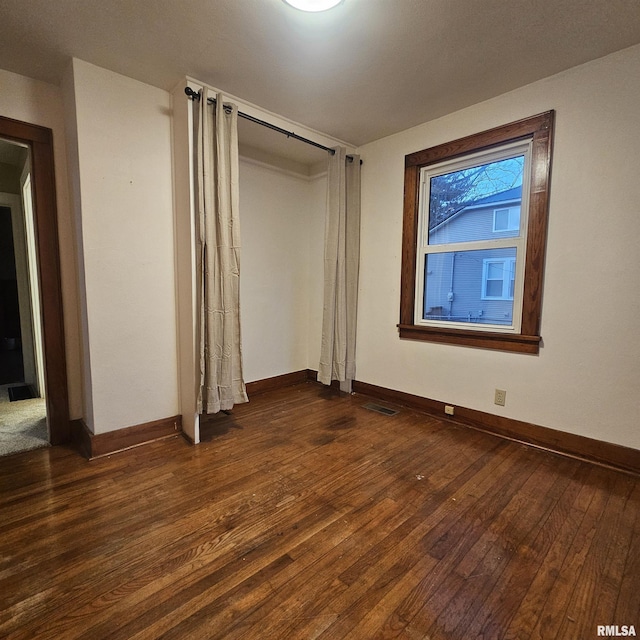 unfurnished bedroom featuring dark wood-type flooring