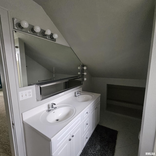 bathroom featuring vanity and vaulted ceiling