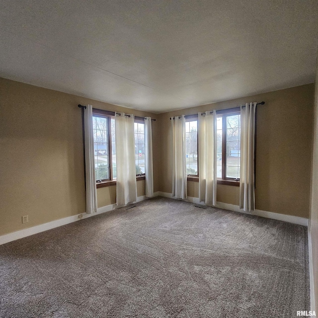 carpeted spare room featuring a textured ceiling