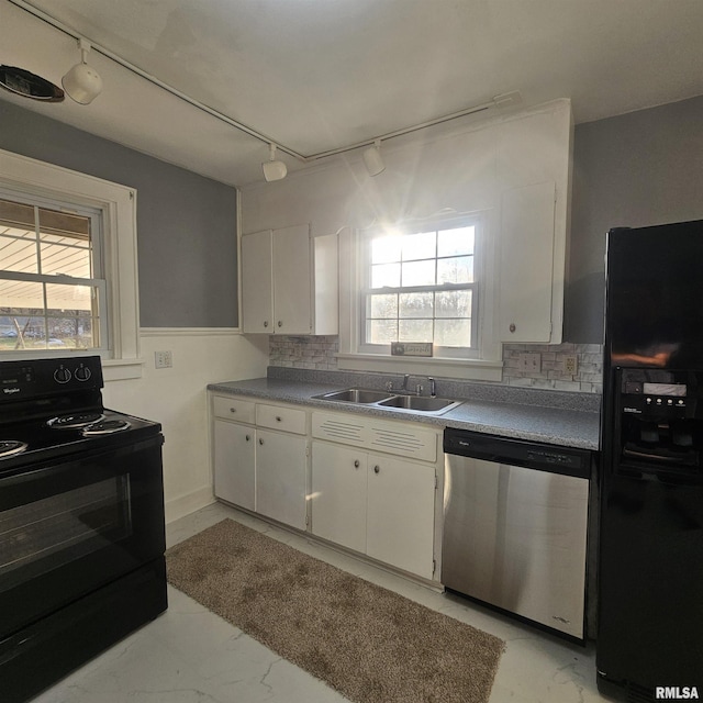 kitchen featuring a wealth of natural light, sink, white cabinets, and black appliances