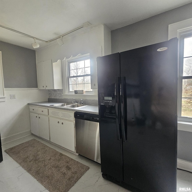 kitchen with white cabinets, black fridge with ice dispenser, stainless steel dishwasher, and a healthy amount of sunlight