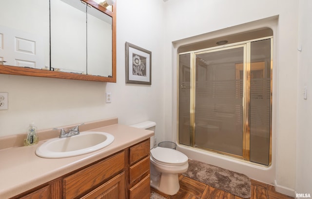 bathroom with vanity, toilet, and walk in shower