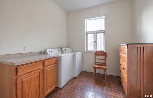 washroom featuring washer and dryer, dark parquet floors, and cabinets