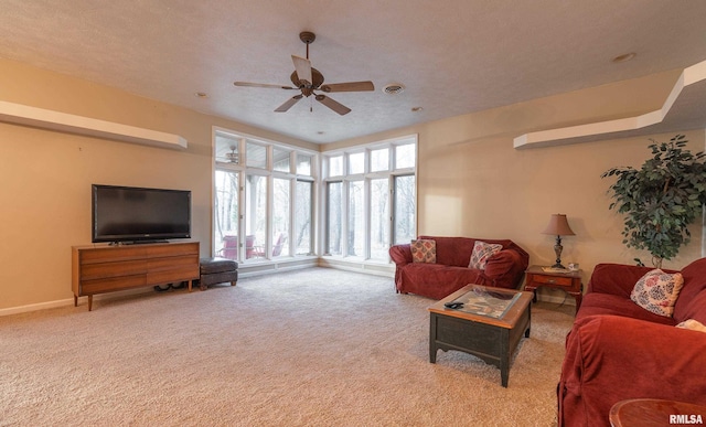 carpeted living room with a textured ceiling and ceiling fan