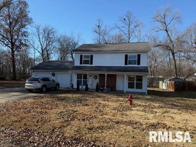 view of front property with covered porch and a garage