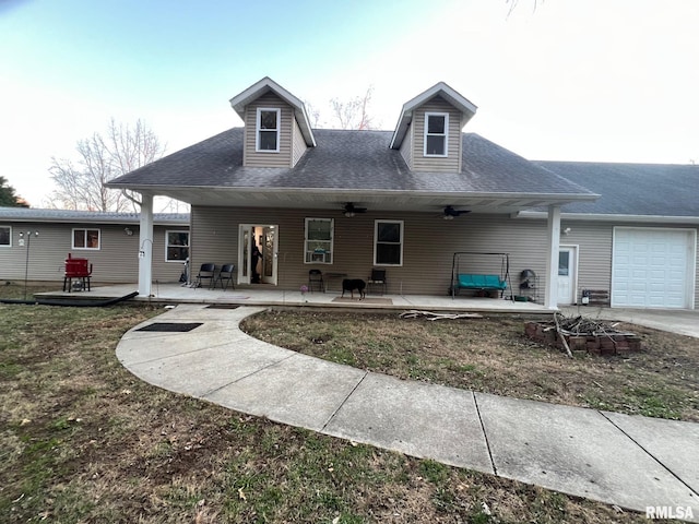 back of property featuring a patio, a garage, and ceiling fan