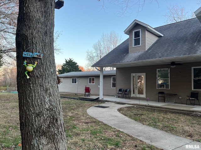 rear view of house with ceiling fan and a patio