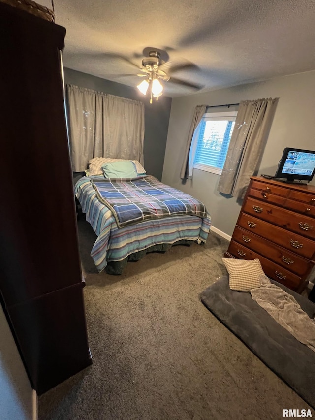 carpeted bedroom with ceiling fan and a textured ceiling