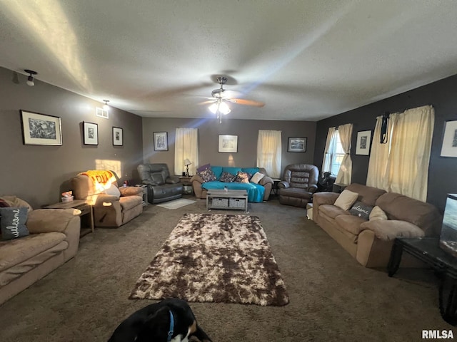 living room featuring carpet flooring, ceiling fan, and a textured ceiling