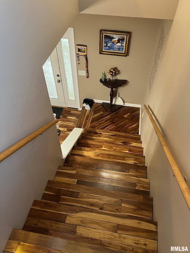 stairs with hardwood / wood-style flooring