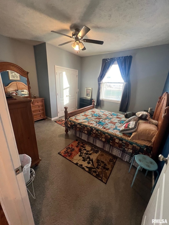 carpeted bedroom with ceiling fan and a textured ceiling