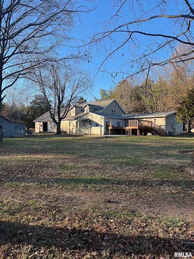 view of front of house featuring a front yard and a deck