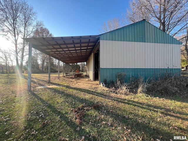 view of outdoor structure with a yard and a carport