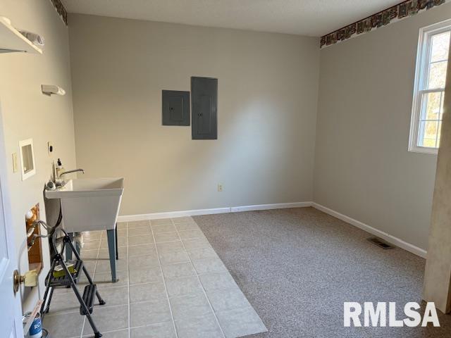 14892 Fowler School Rd, Marion, IL 62959 - spare room featuring electric panel and tile patterned floors