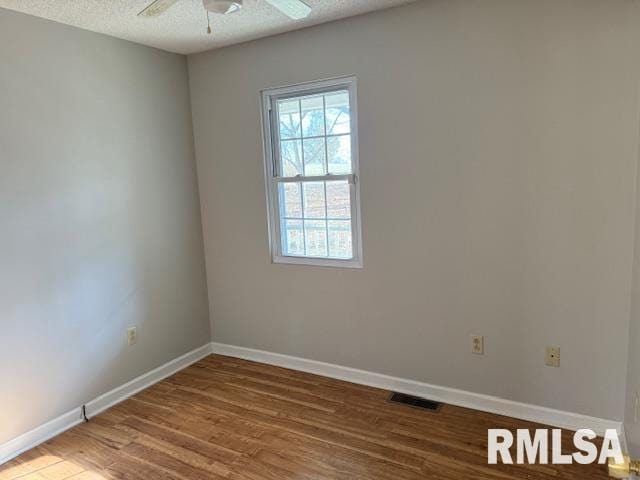 14892 Fowler School Rd, Marion, IL 62959 - empty room featuring wood finished floors, ceiling fan, and a textured ceiling