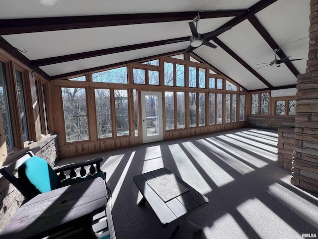 unfurnished sunroom with ceiling fan and lofted ceiling with beams