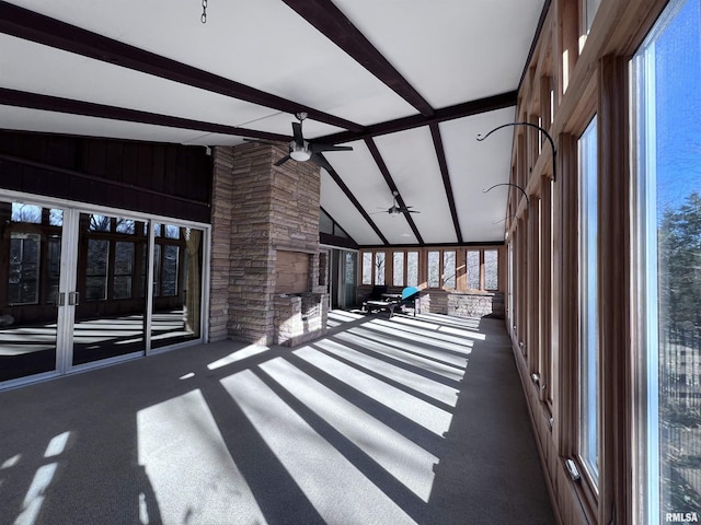 unfurnished sunroom featuring lofted ceiling with beams