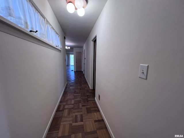 hallway featuring dark parquet flooring