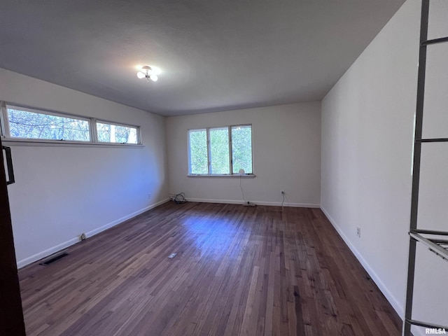 spare room featuring dark hardwood / wood-style flooring