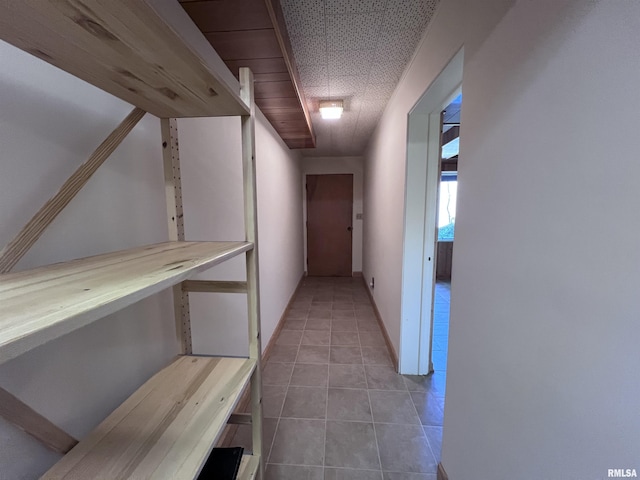 hall featuring light tile patterned floors