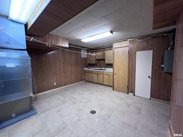 basement with electric panel and wooden walls