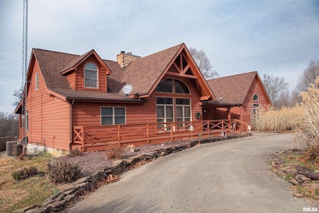 log home featuring a deck and central AC unit