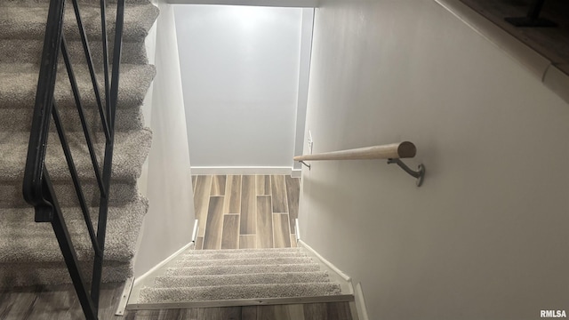 stairway featuring hardwood / wood-style floors