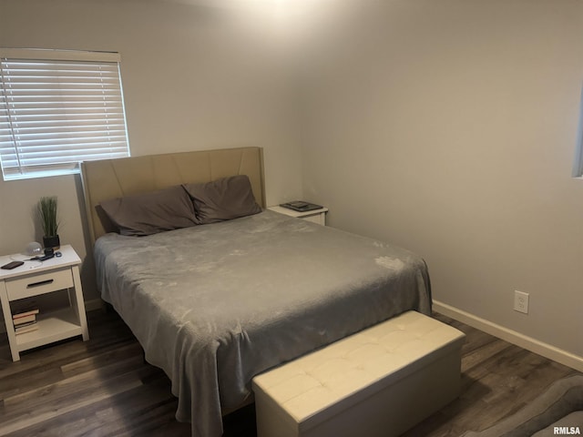 bedroom with dark hardwood / wood-style flooring