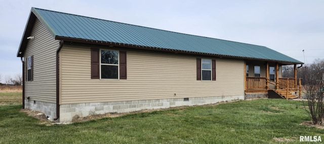 view of side of home featuring a lawn and a porch