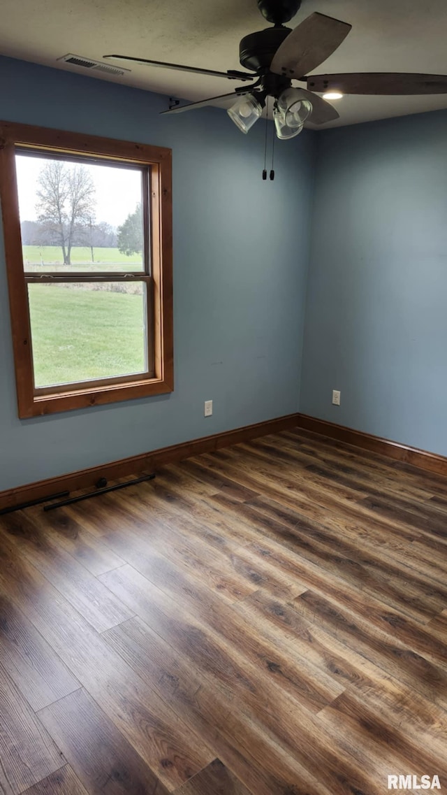 spare room with ceiling fan and dark wood-type flooring