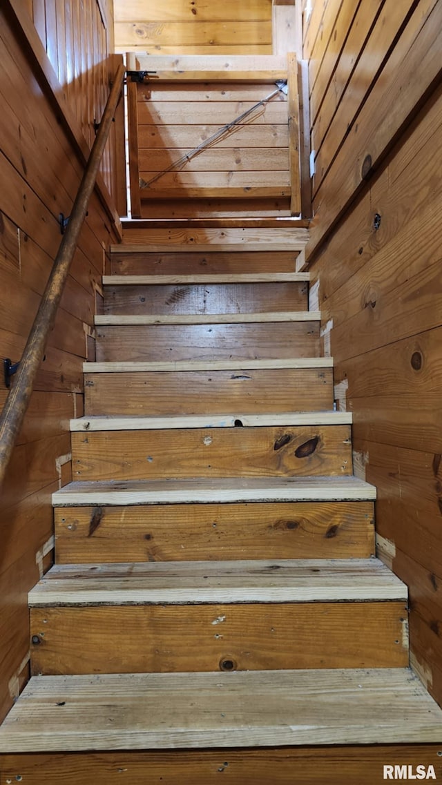 staircase with wood walls