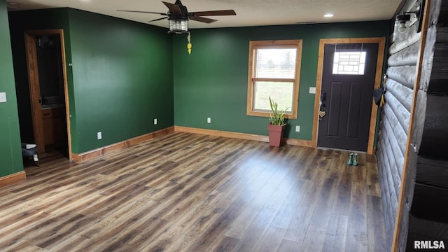 foyer entrance featuring a textured ceiling, ceiling fan, and dark hardwood / wood-style floors