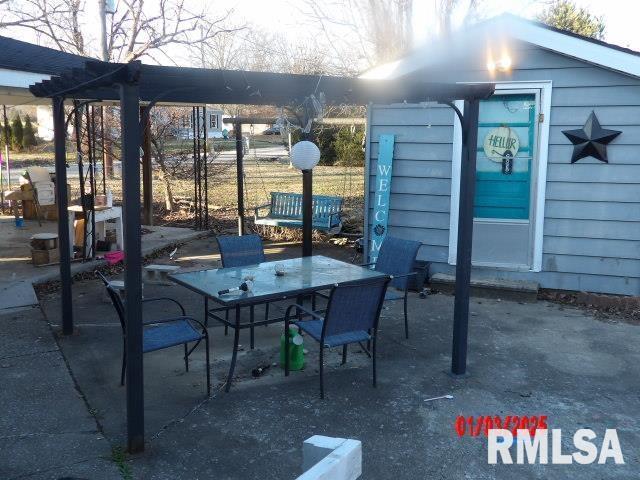 view of patio / terrace with outdoor dining space and an outdoor structure