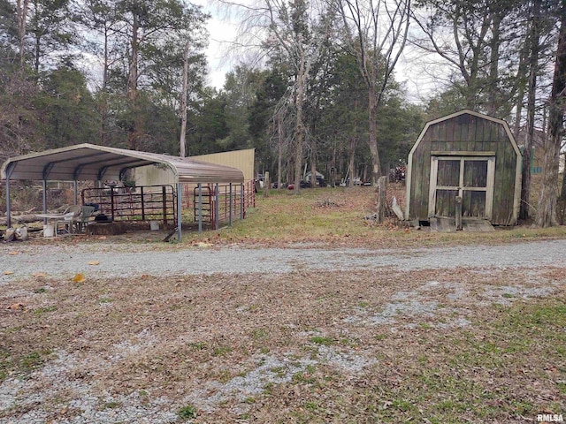 view of yard with a storage unit and a carport