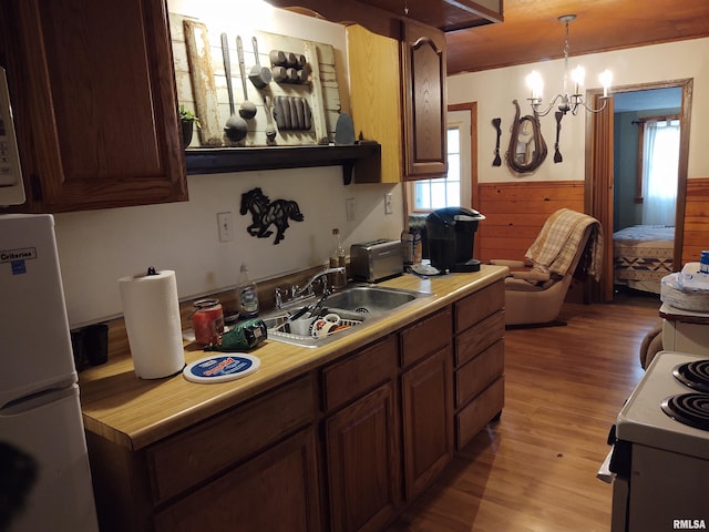 kitchen with a chandelier, decorative light fixtures, plenty of natural light, and sink