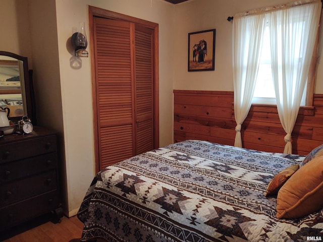 bedroom with hardwood / wood-style flooring and a closet